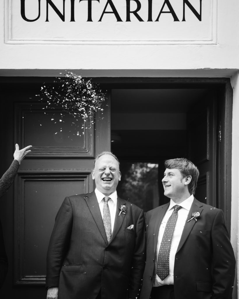 Nick and Andrew leaving the Unitarian Chapel under a shower of confetti.